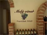 Detail na dřevěný stojan s nabízenými láhvemi (Malý vinař František Mádl).